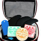 OBRTO Wax Stash containers in a surf travel case alongside fins and a wax comb