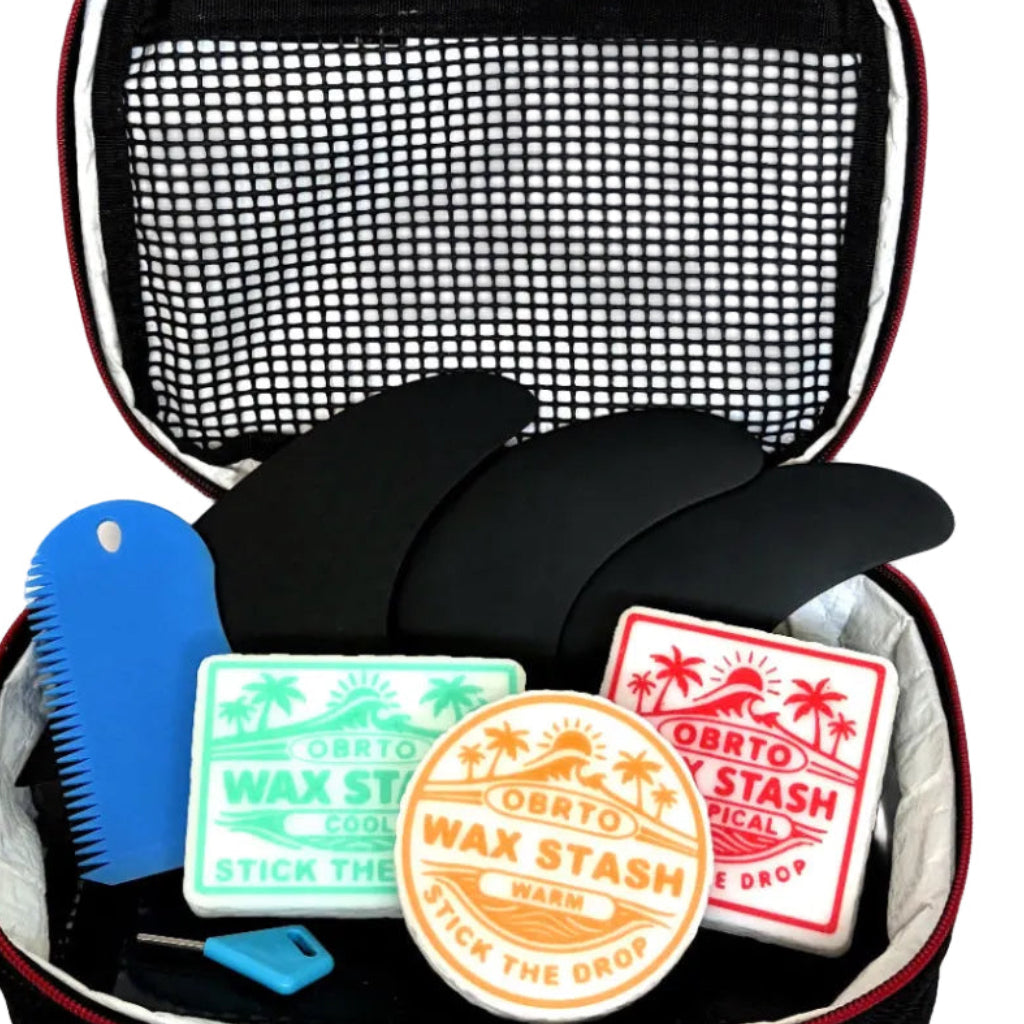 OBRTO Wax Stash containers in a surf travel case alongside fins and a wax comb